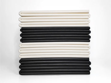 abit.of foldable yoga mats stacked in Ivory and Black colourways