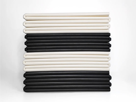 abit.of foldable yoga mats stacked in Ivory and Black colourways